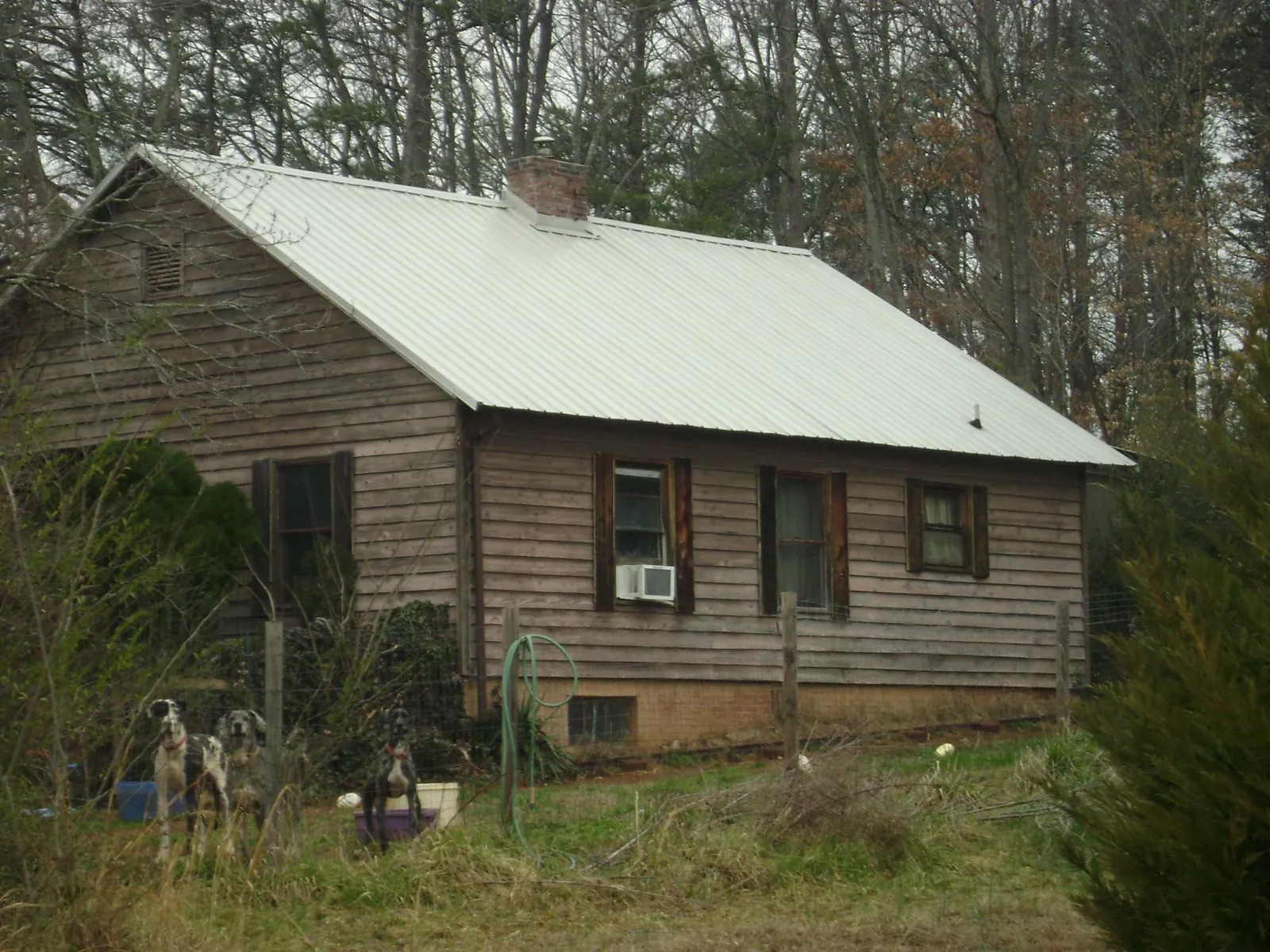 White metal roof on an old wood sided farmhouse, from a Metal Roof Installation job in Rosalia